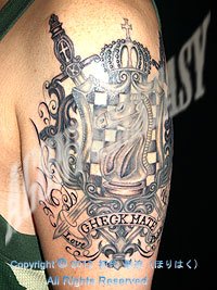 左二の腕に楯（タテ）＆剣＆リボンのタトゥー画像【エゴニー アンド エクスタシー タトゥーデザインスタジオ】彫迫